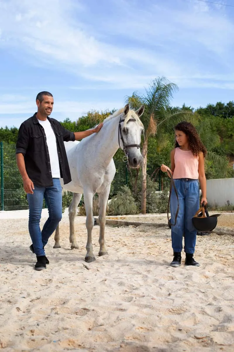Paso Fino horse and rider on a forest trail leading to Caribbean beach in Isabela Puerto Rico, horseback riding on the beach in Puerto Rico on a native Puerto Rican Paso Fino breed